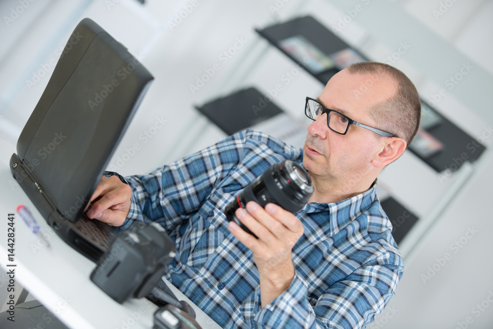 technician examining and repairing dslr camera technician examining and repairing dslr camera