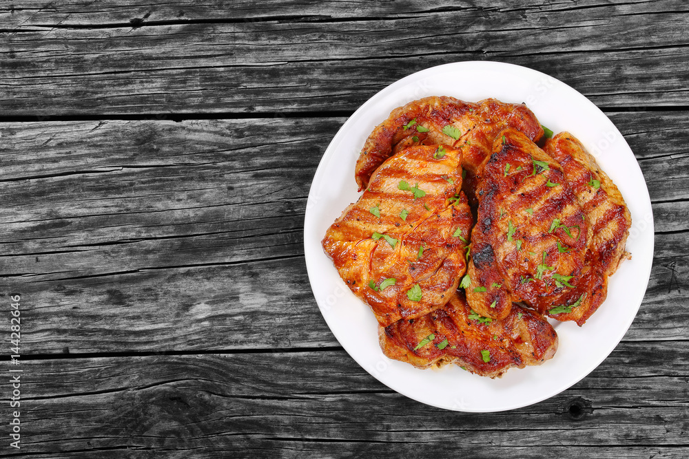 juicy pork chops on white plate juicy pork chops on white plate