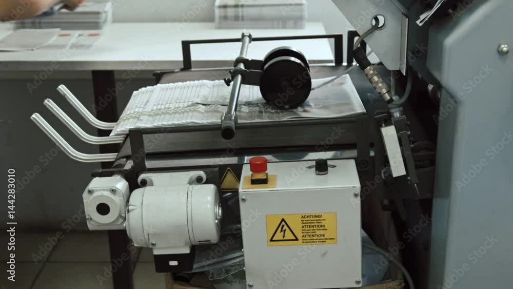 Typography - polygraph printing process - a female's hand completes a paper for a newspaper Typography - polygraph printing process - a female's hand completes a paper for a newspaper