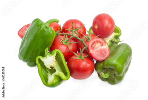 Branch of the ripe red tomatoes and green bell peppers