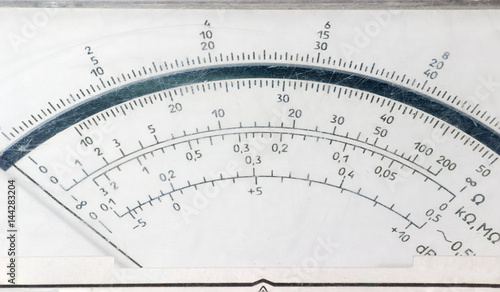 Display face of the old analog multimeter closeup photo