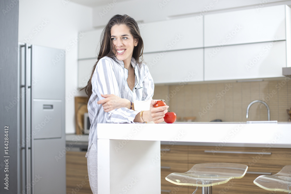 Morning scene. Happy Woman Preparing Healthy Breakfast With Tomatoes Morning scene. Happy Woman Preparing Healthy Breakfast With Tomatoes