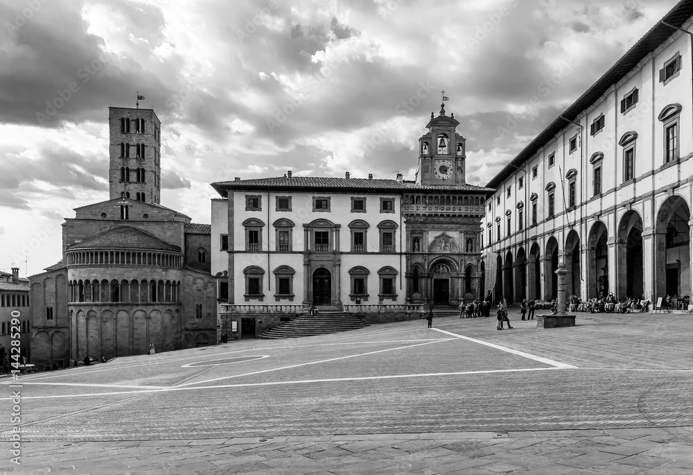 Beautiful black and white view of the Piazza Grande square in the historic center of Arezzo, Italy, under a dramatic sky