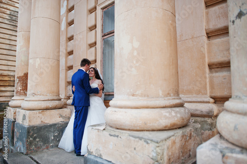 Wedding couple in love stay against old vintage palace. © AS Photo Family