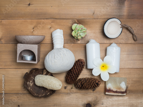 Aromatherapy product Spa set ,candle ,soap,coconut,flower,shell, massage with wood background .