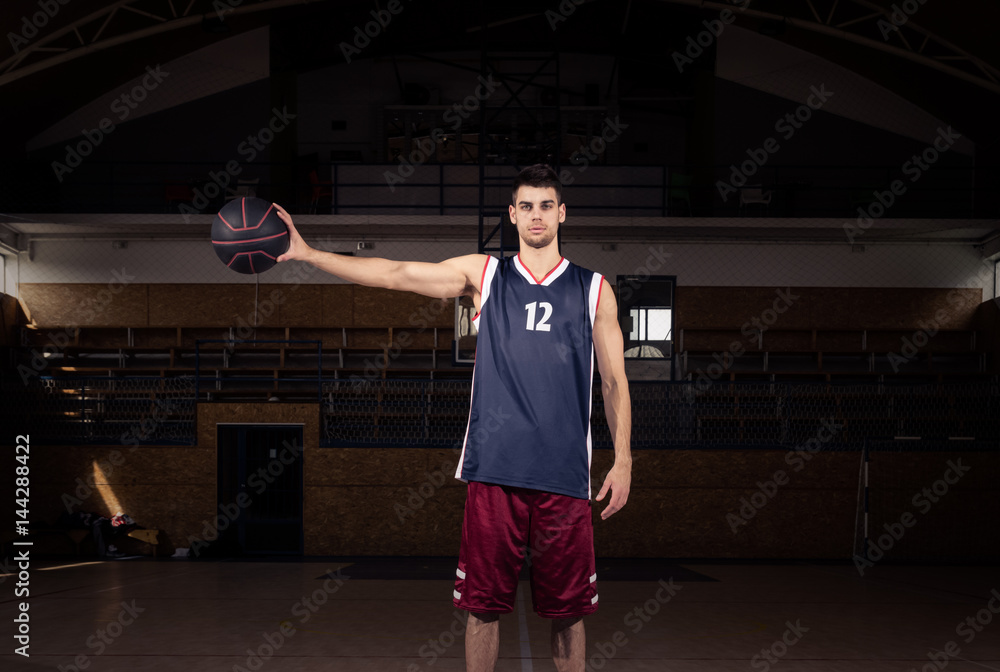 basketball player holding ball in one hand
