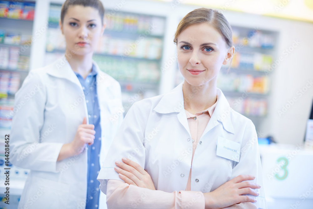 Two female pharmacists at drug store