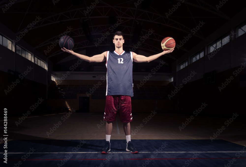 Naklejka premium basketball player holding two balls, two hands