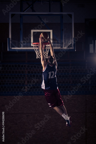 basketball player slam dunk, in air