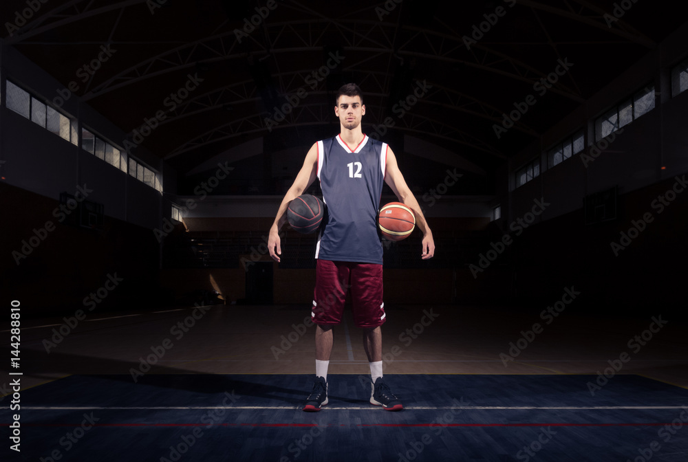 Naklejka premium basketball player two balls posing