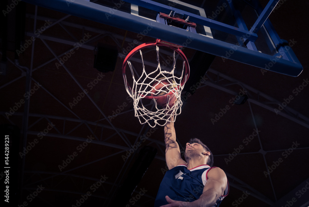 Naklejka premium basketball player, low angle view, slam dunk