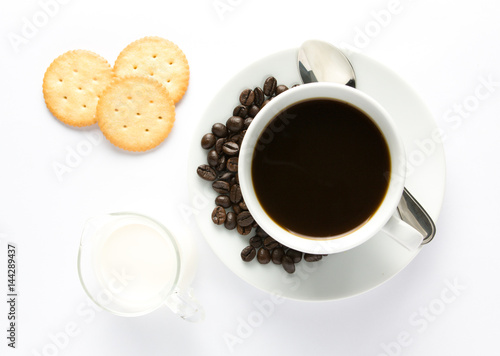 Cup of coffee and milk with biscuit
