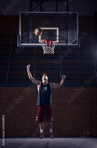 one young basketball player, shooting ball in air