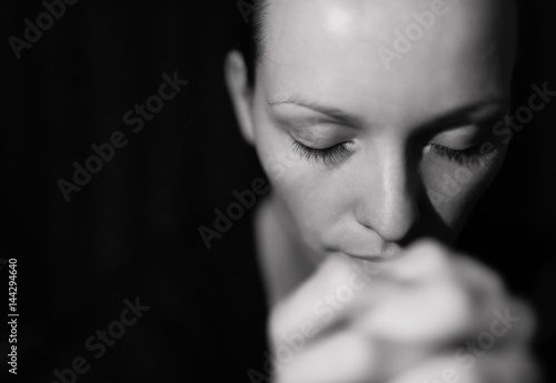 Photography Portrait of woman praying and feeling desperate.
