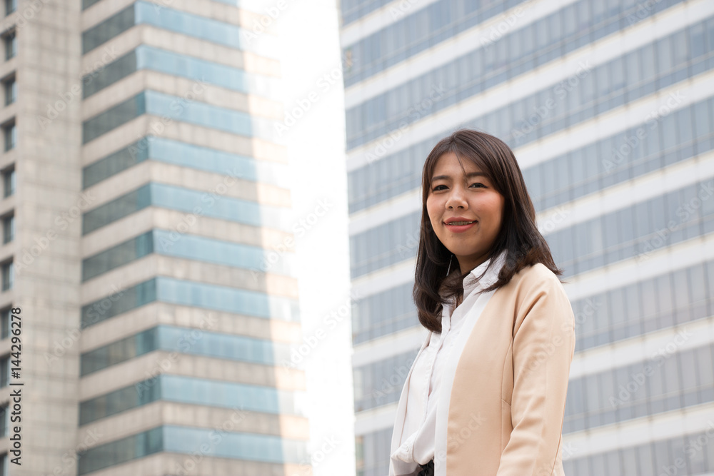 Business woman is standing in front of modern office Business woman is standing in front of modern office