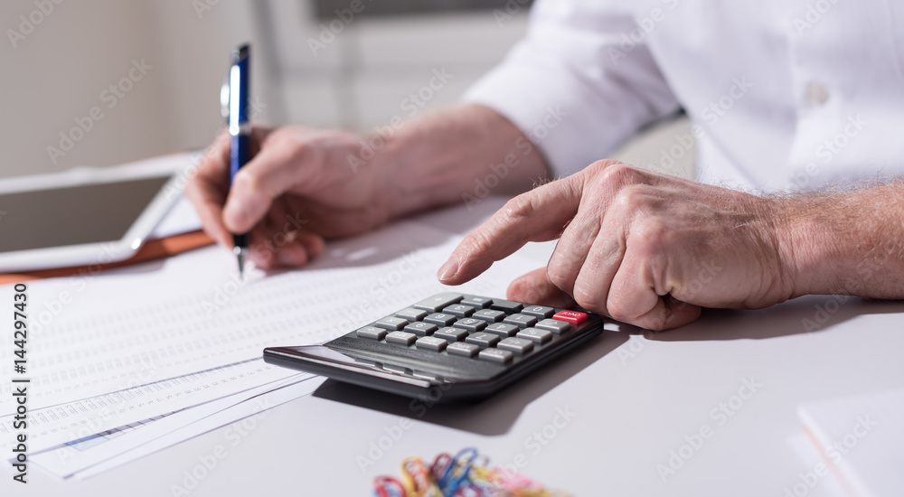 Businessman using a calculator Businessman using a calculator