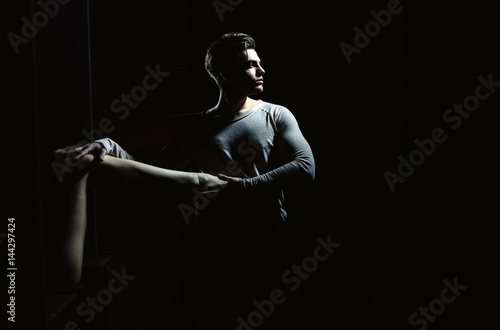 Handsome man posing with sexy naked female leg in hands © Volodymyr