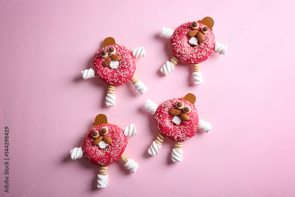 Funny decorated donuts on table Funny decorated donuts on table