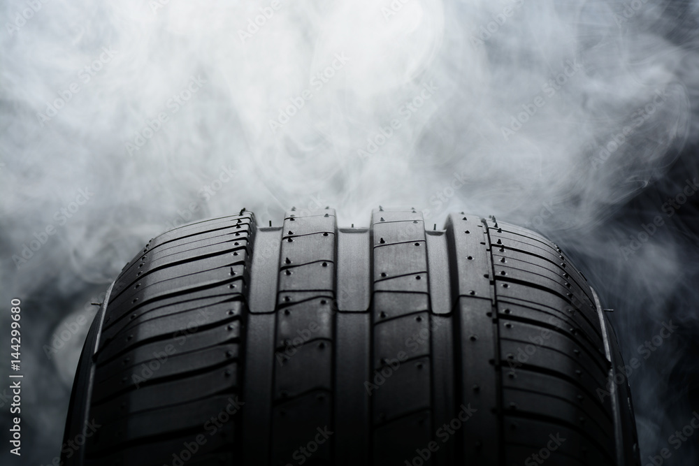 Car tire and smoke on black background Stock Photo | Adobe Stock