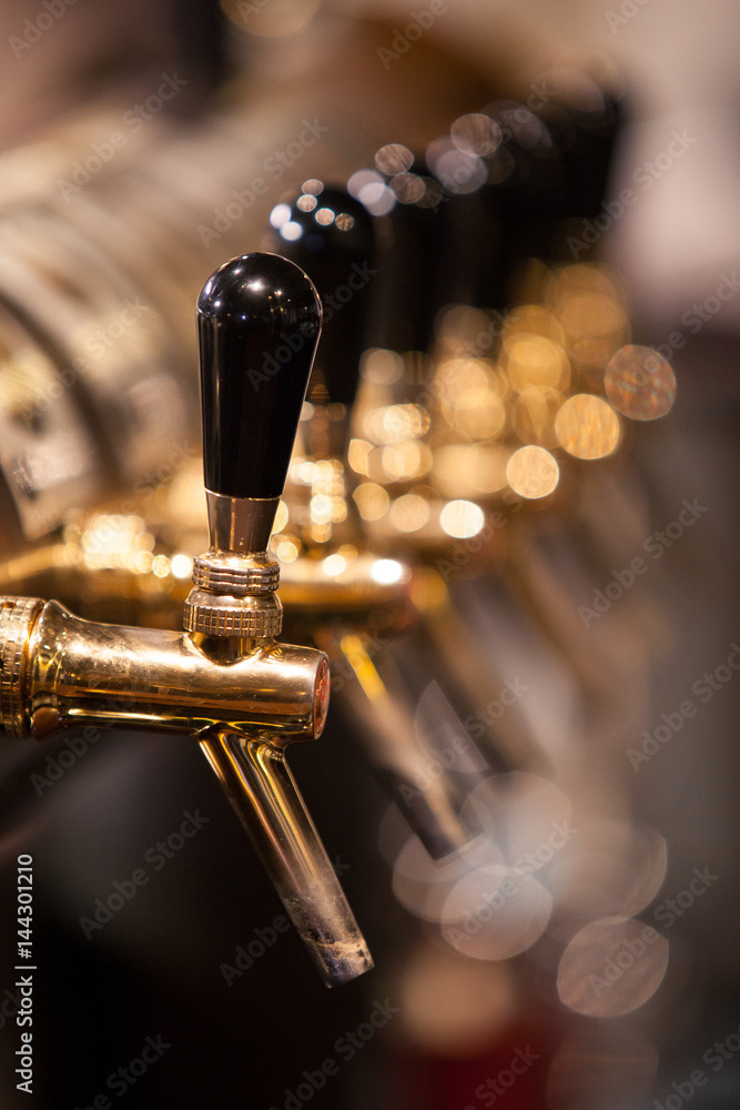 Obraz premium A lot of Golden beer taps at the bar