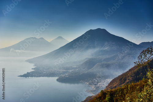 Highlands with volcanoes at Lake Atitlan in Guatemala / Foggy morning at lake in Guatemala in the morning hours