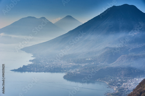 Highlands with volcanoes at Lake Atitlan in Guatemala / Foggy morning at lake in Guatemala in the morning hours