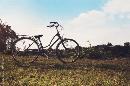 vintage bicycle on field © Win Nondakowit