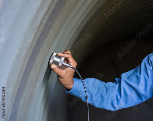 Ultrasonic test to detect imperfection or defect of wall thickness steel plate in Workshop, NDT Inspection. photo