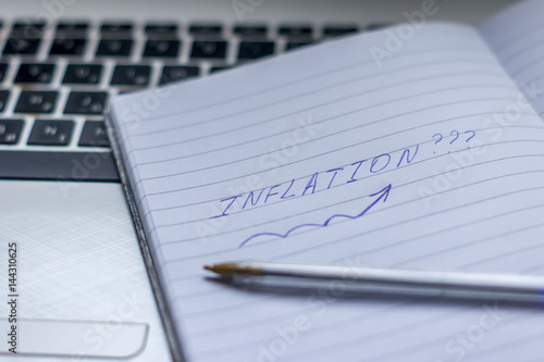 Inflation : Wrote Words On a handbook with note book, pen and notebook