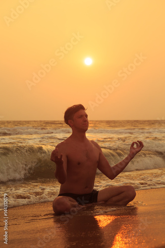 Athletic man doing sports on the beach.