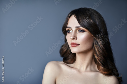 Beautiful woman portrait with long hair on dark background