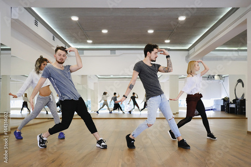 Fototapeta Naklejka Na Ścianę i Meble -  Group of young modern dancers dancing in the studio. Sport, dancing and urban culture concept