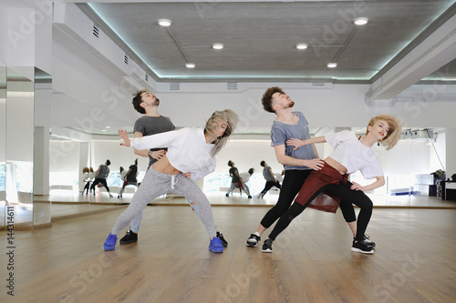 Group of young modern dancers dancing in the studio. Sport, dancing and urban culture concept