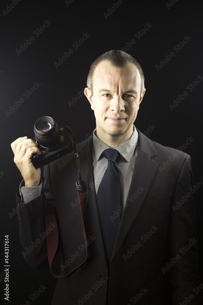 Naklejka premium Photographer in studio in suit