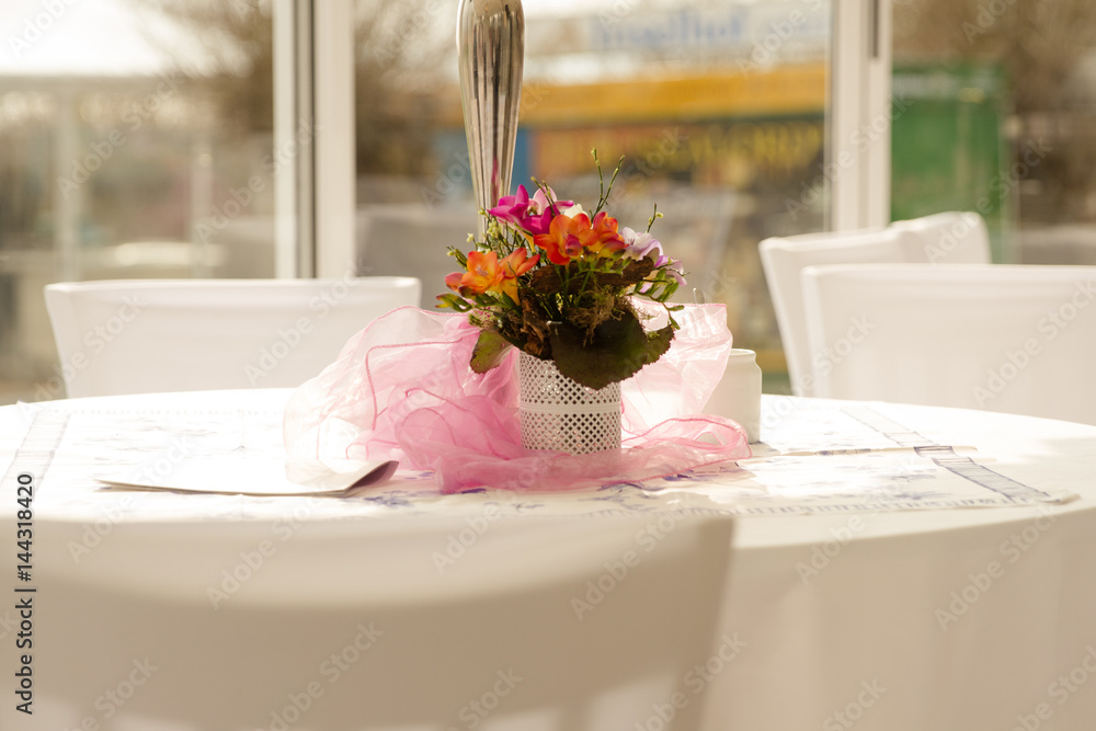 Obraz premium Tischdekoration mit Blumen und weißer Tischdecke