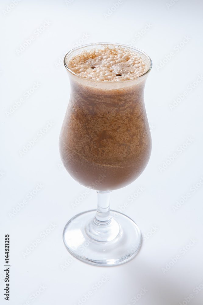 Delicious milkshake with a leaf of mint on top on a white background Delicious milkshake with a leaf of mint on top on a white background