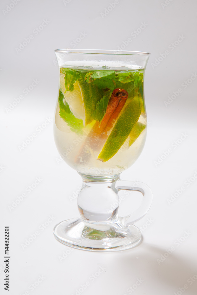 Glass of tea with mint,cinnamon and lime isolated on white Glass of tea with mint,cinnamon and lime isolated on white