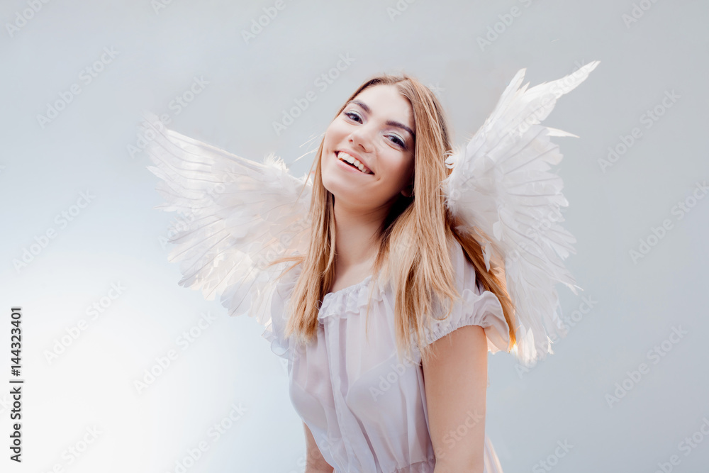 An angel from heaven. Young, wonderful blonde girl in the image of an angel with white wings. An angel from heaven. Young, wonderful blonde girl in the image of an angel with white wings.