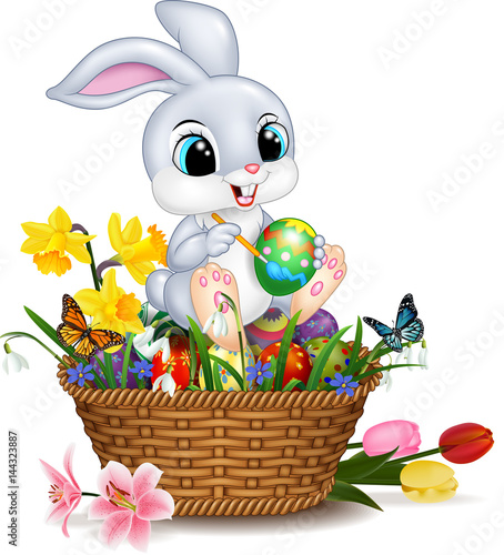 Cartoon little rabbit painting an Easter egg