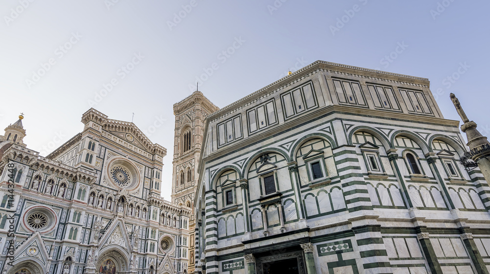 Beautiful bottom view of the Baptistery and Duomo Cathedral of Santa Maria del Fiore in Florence, Italy, on a sunny day