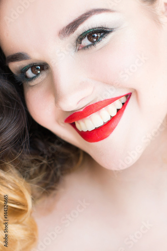 Portrait of a girl with a beautiful open smile and bright make-up. Beautiful smile and white teeth