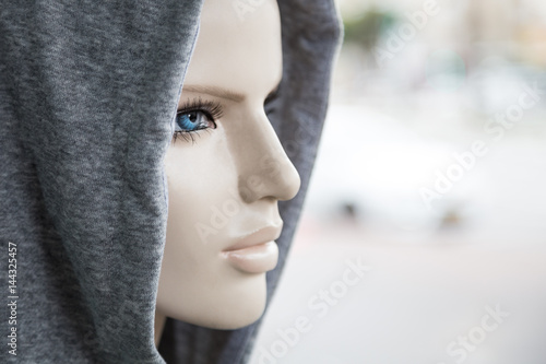 Close up of the head of plastic fashion mannequin with blue eyes and red lips. Design and blogger concept. Background of  beautiful woman face with neutral expression. photo