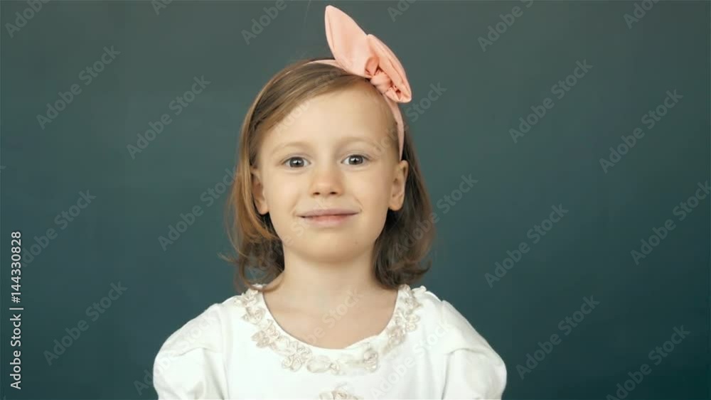 Adorable and happy little girl dancing. on green background, smiling child portrait Adorable and happy little girl dancing. on green background, smiling child portrait