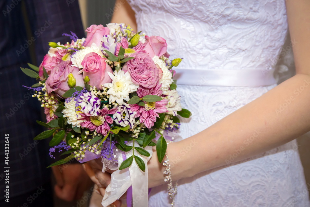 Hands and rings bride groom on the background of a wedding bouquet. Hands and rings bride groom on the background of a wedding bouquet.
