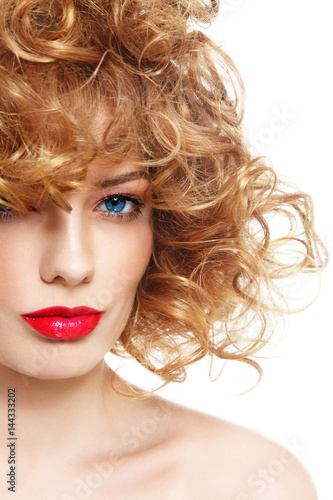Portrait of young beautiful woman with curly hair and red lipstick over white background, copy space