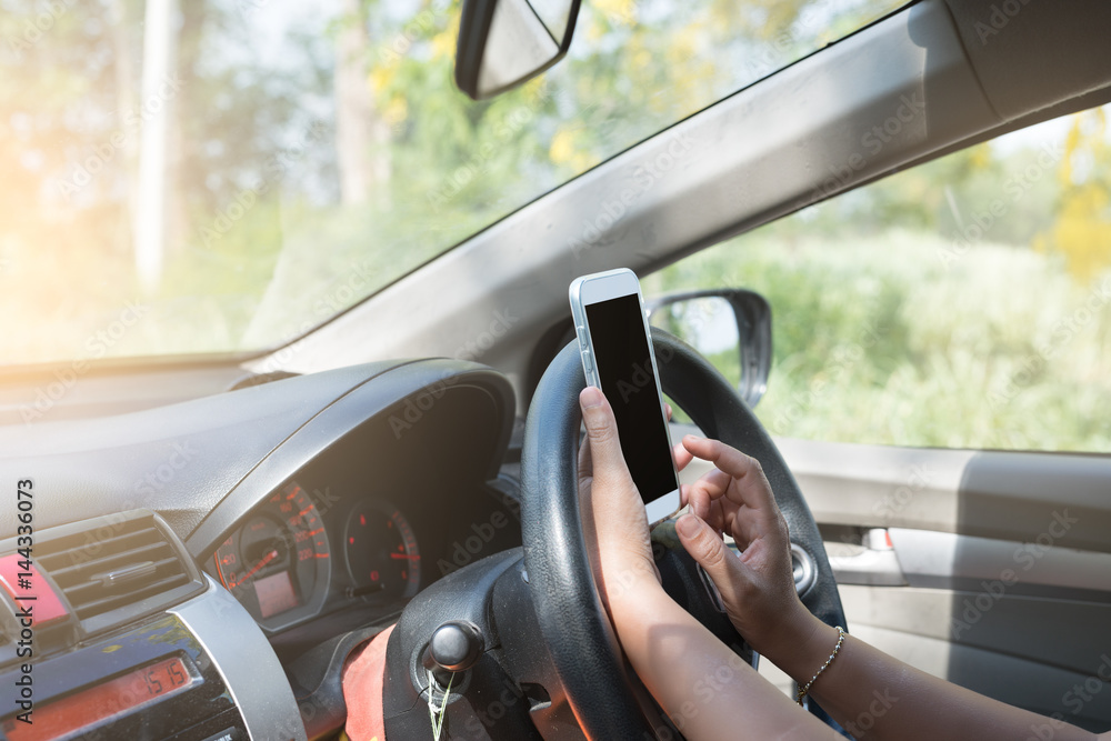 Woman play smartphone while driving