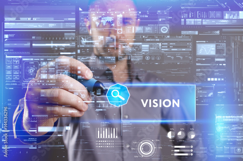 Business, Technology, Internet and network concept. Young businessman working on a virtual screen of the future and sees the inscription: Vision