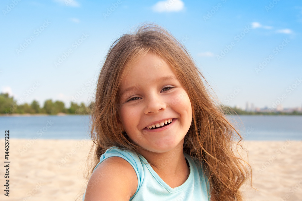 Little girl on the beach, long hair, laughing, happy, portrait, kid Little girl on the beach, long hair, laughing, happy, portrait, kid