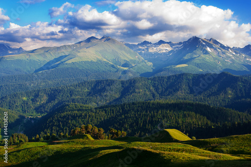 A beautiful view of the mountains of the Western Caucasus. White clouds in the blue sky