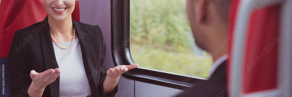 Businesspeople talking on a train